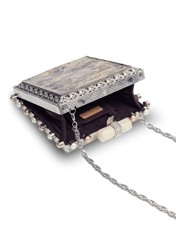 Salma Mother of Pearl clutch bag by The Tan Clan, featuring a sleek design with shimmering pearl details and elegant craftsmanship.