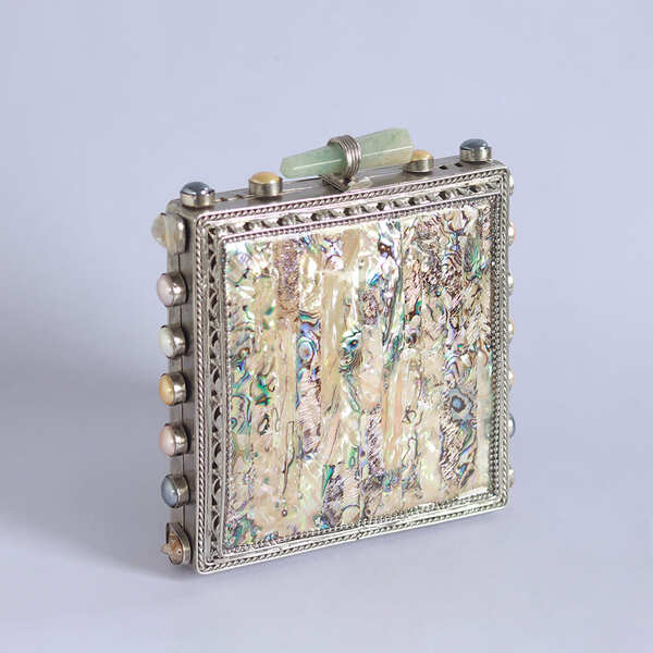 Salma mother of pearl clutch bag by The Tan Clan with elegant pearl detailing and a sleek, rounded shape.