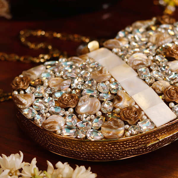 Seher embellished brass clutch in gold with intricate designs, elegant accessory by The Tan Clan for special occasions.