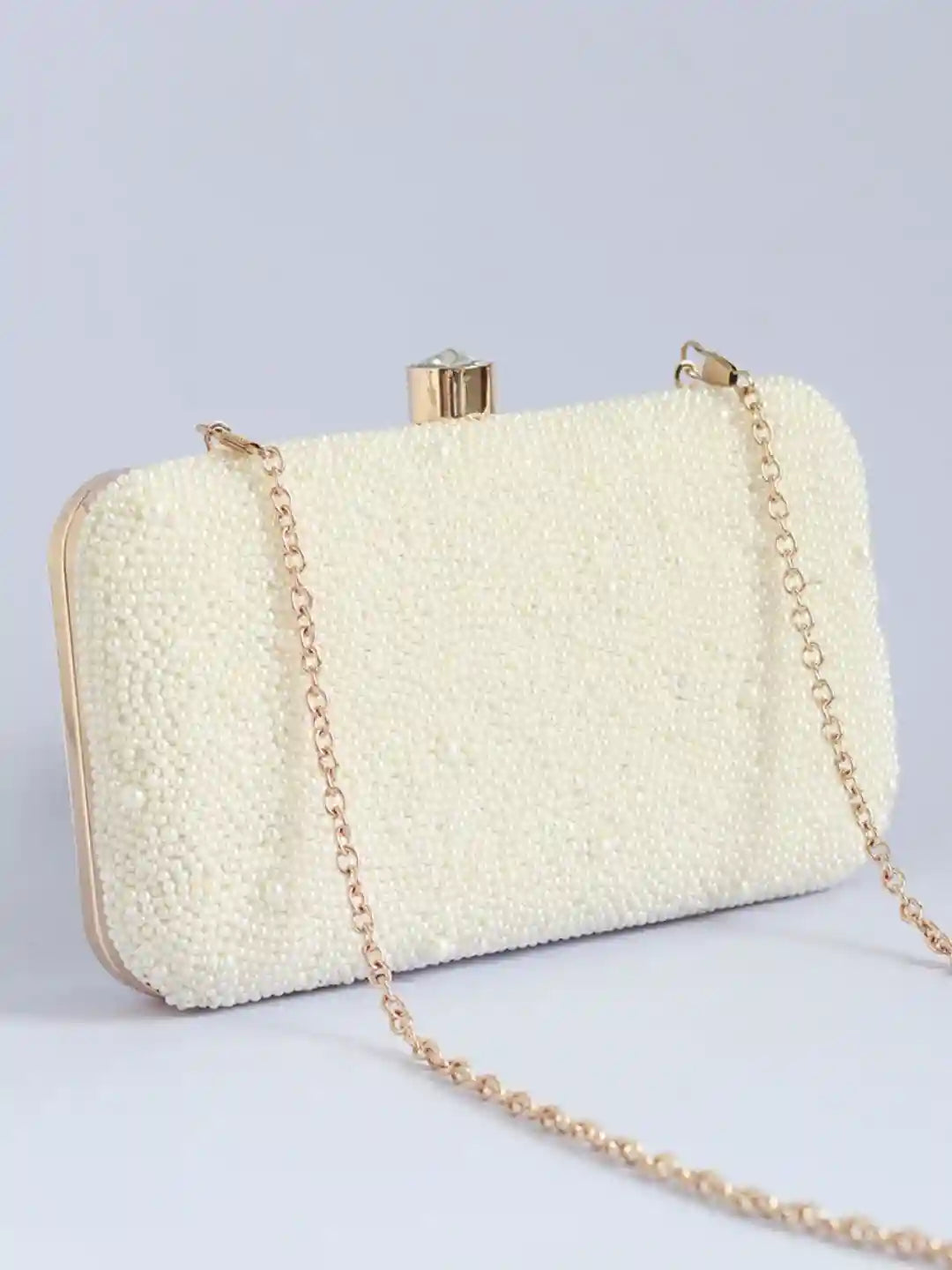 Shwet all-white pearl hand-embroidered clutch by The Tan Clan with intricate detailing and elegant design.