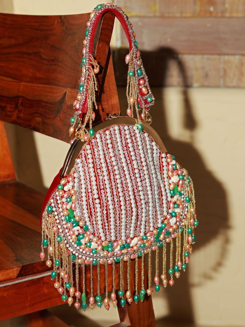 Red Sona Pearl tasselled batua with detachable handle, traditional Indian purse featuring intricate beadwork and elegant design.