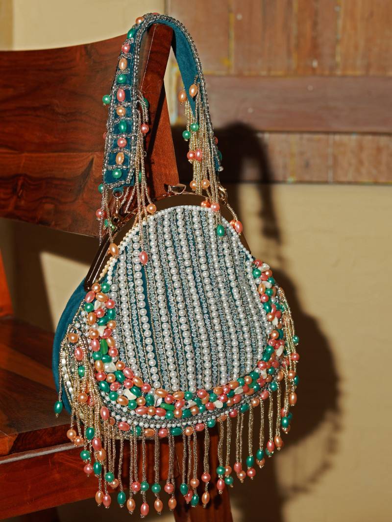 Green Sona Pearl Tasselled Batua bag with detachable handle from The Tan Clan, featuring traditional design and intricate pearl embellishments.
