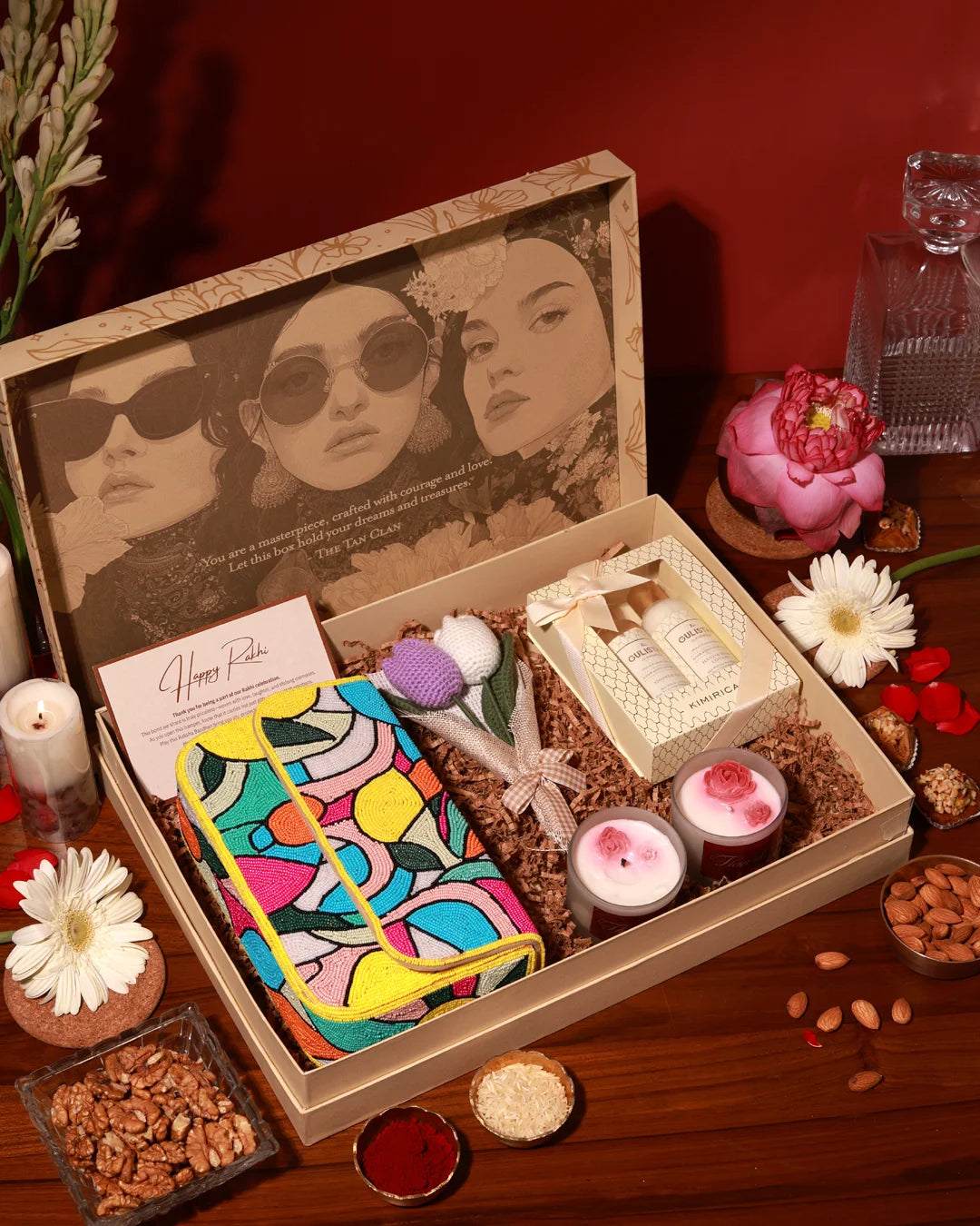 The Luxe Blossom Hamper Poppy by The Tan Clan with floral-themed packaging and assorted luxury gift items inside
