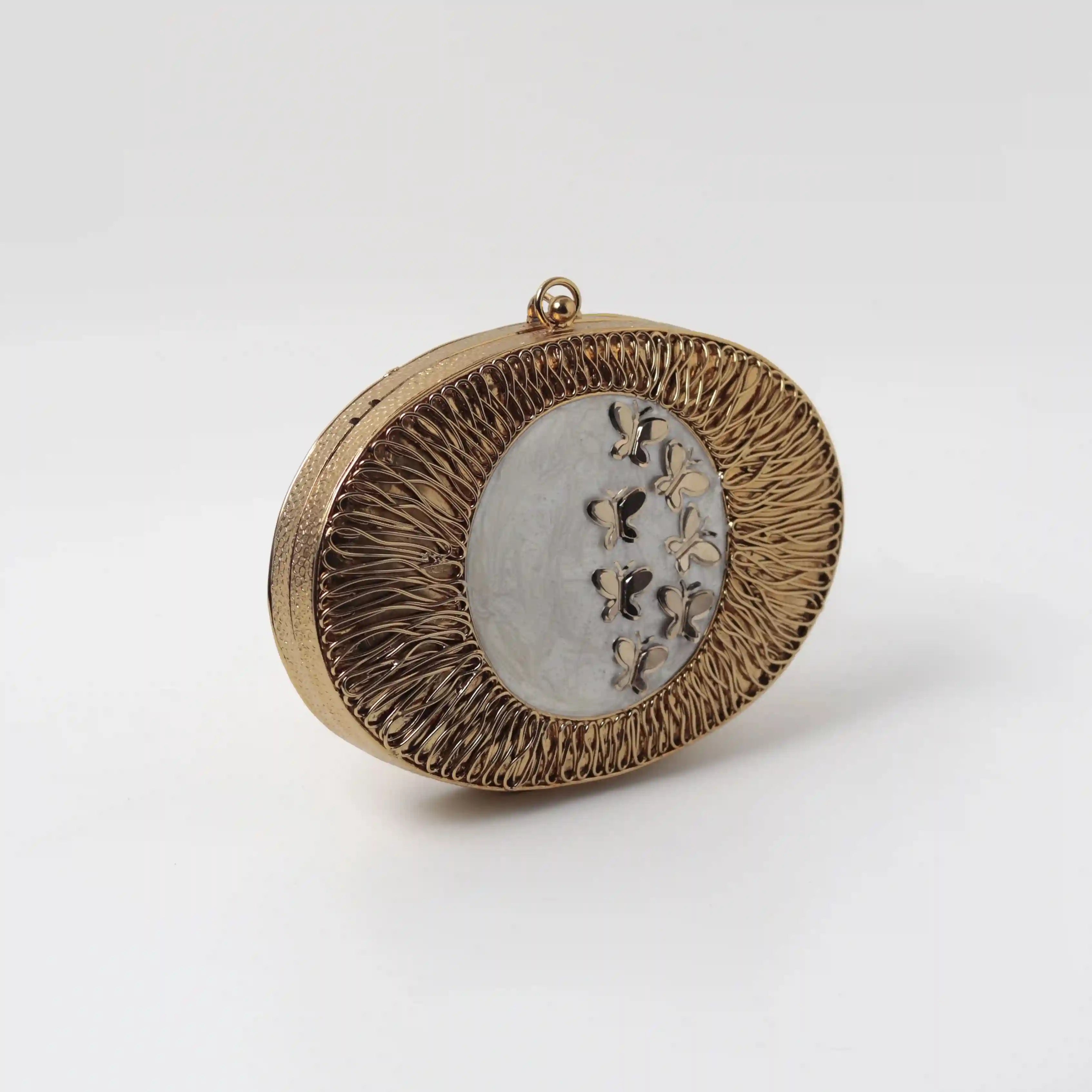 Titly wirework clutch by The Tan Clan featuring Mother of Pearl embellishments and intricate design craftsmanship.