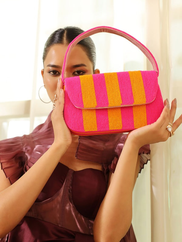 Orange and pink tulip-shaped baguette bag with handle from The Tan Clan, featuring a stylish and compact design.