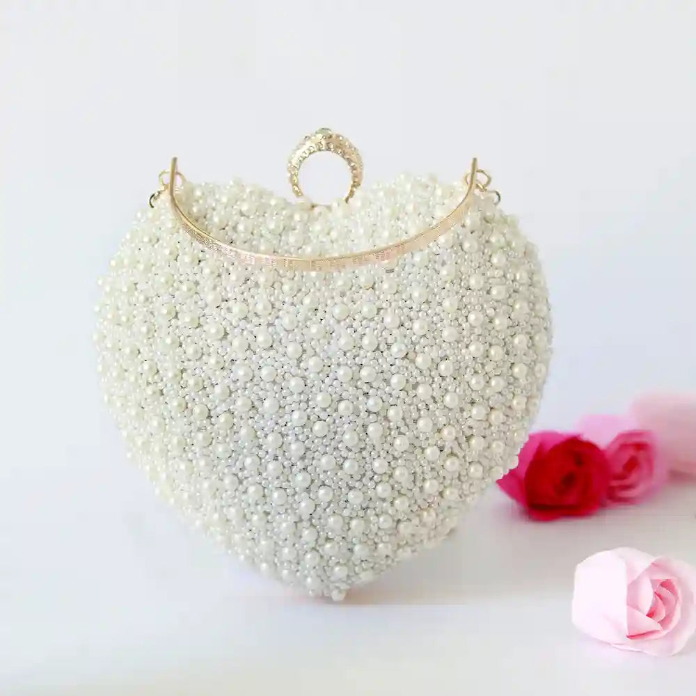 Ulfat All White Pearl Hand Embroidered Heart Clutch by The Tan Clan with pearl embellishments and intricate embroidery.