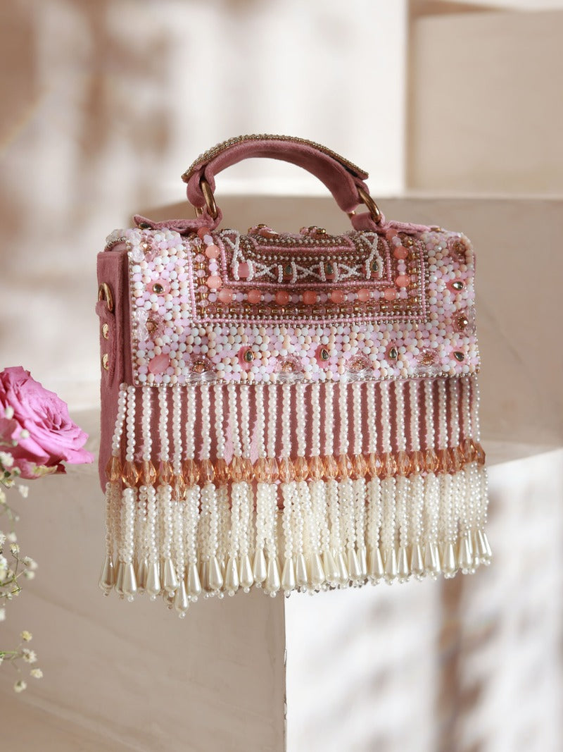 Pink Kiara flap-over bag with handle by The Tan Clan, featuring a stylish design and spacious interior.