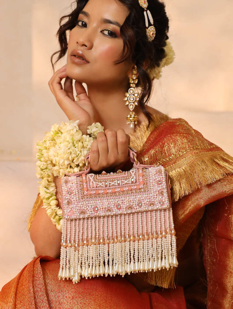 Kiara beige flap-over bag with handle by The Tan Clan, featuring a structured design and top handle for versatile style.