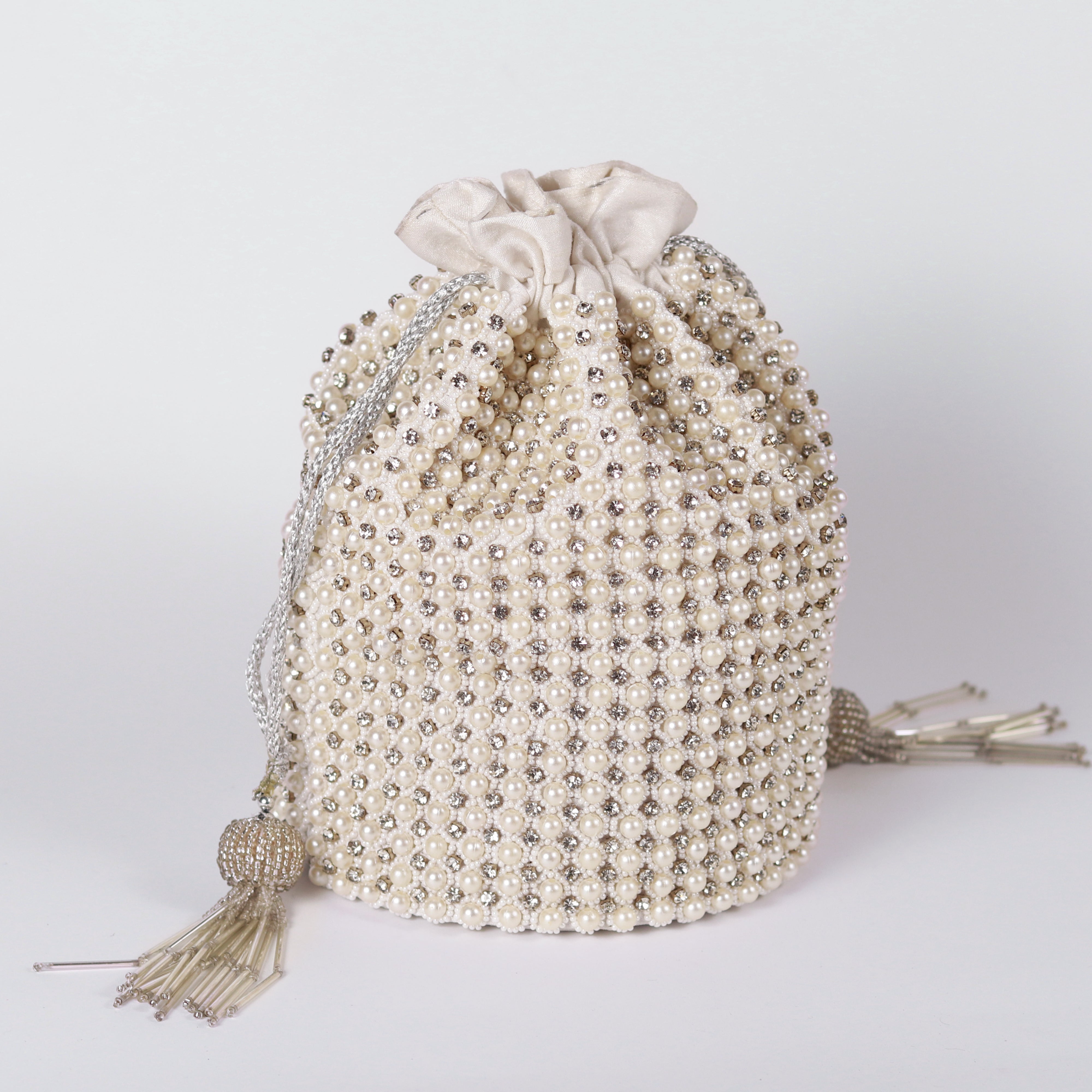 Embroidered handle Chhaya Potli bag by The Tan Clan featuring intricate embroidery and traditional design.