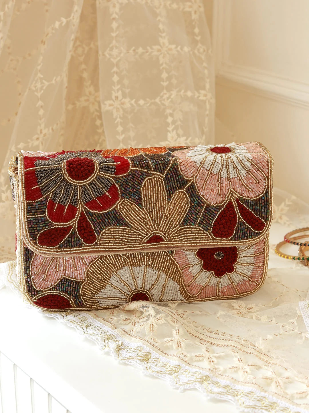 Beaded handbag with floral pattern on a lace surface