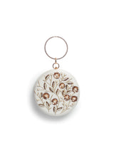White round clutch bag with hand embroidery and the Falaq design from The Tan Clan, featuring intricate embroidery details.