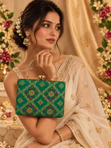 Light green Mahi casket clutch by THE TAN CLAN featuring a sleek rectangular design with a subtle sheen and elegant clasp.