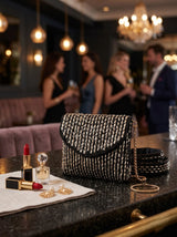 Anaya black envelope bag by THE TAN CLAN featuring a sleek design and minimalist style, suitable for evening or formal occasions.