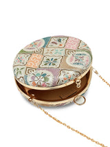 Mughal Round Clutch by The Tan Clan featuring intricate traditional patterns and a round shape in rich, vibrant colors.