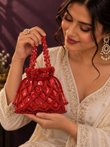 Red sequined tasselled potli bag from THE TAN CLAN featuring intricate embroidery and traditional design.