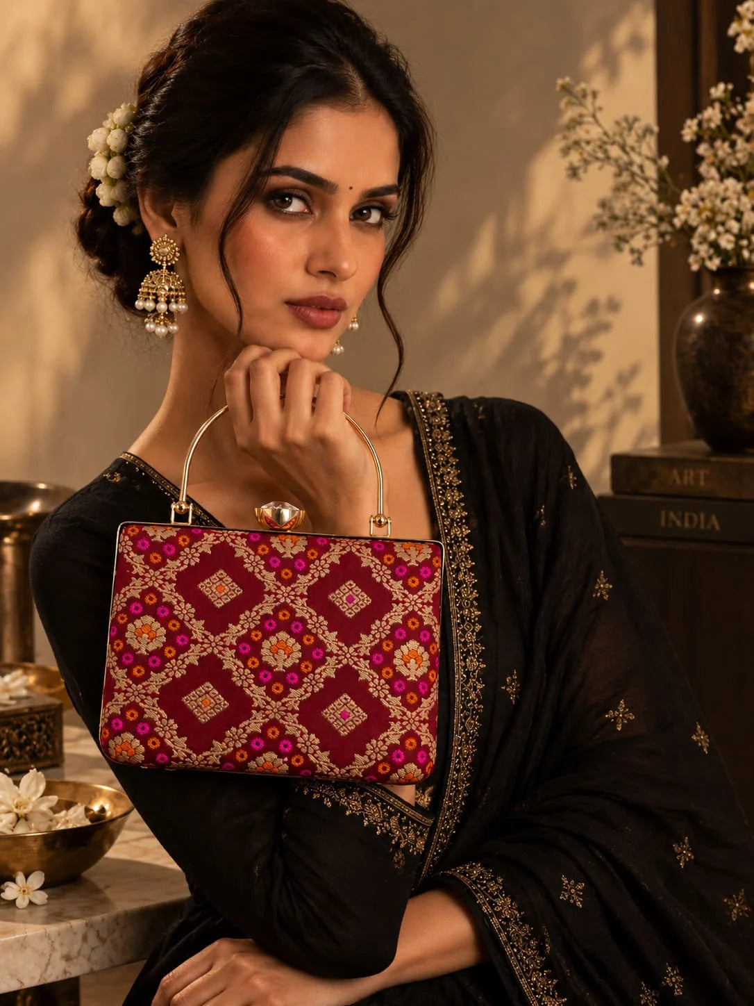 Mahi Red Casket Clutch by THE TAN CLAN featuring a sleek rectangular design with a metallic clasp and textured finish.