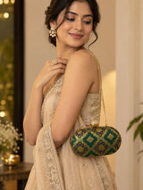 Dark green oval clutch purse by THE TAN CLAN with a sleek, compact design and smooth finish, perfect for evening accessories.
