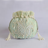 Blue Sukoon hand-embroidered potli bag with pearl handle from The Tan Clan, featuring intricate embroidery and elegant design.