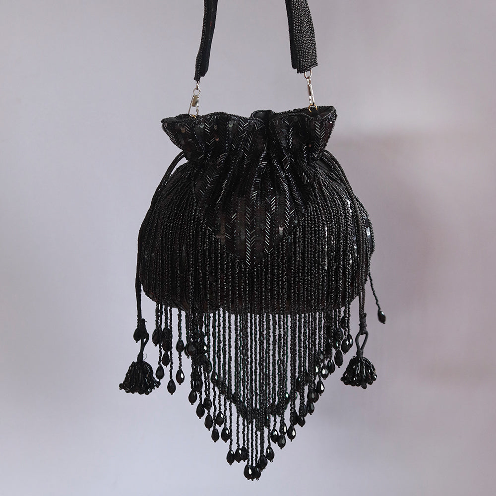 Black Twinkle Heavy Tassels Potli bag with handle by The Tan Clan, featuring decorative tassels and a stylish design.
