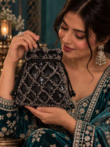 Black sequined tasselled potli bag from THE TAN CLAN with intricate beadwork and traditional Indian design.