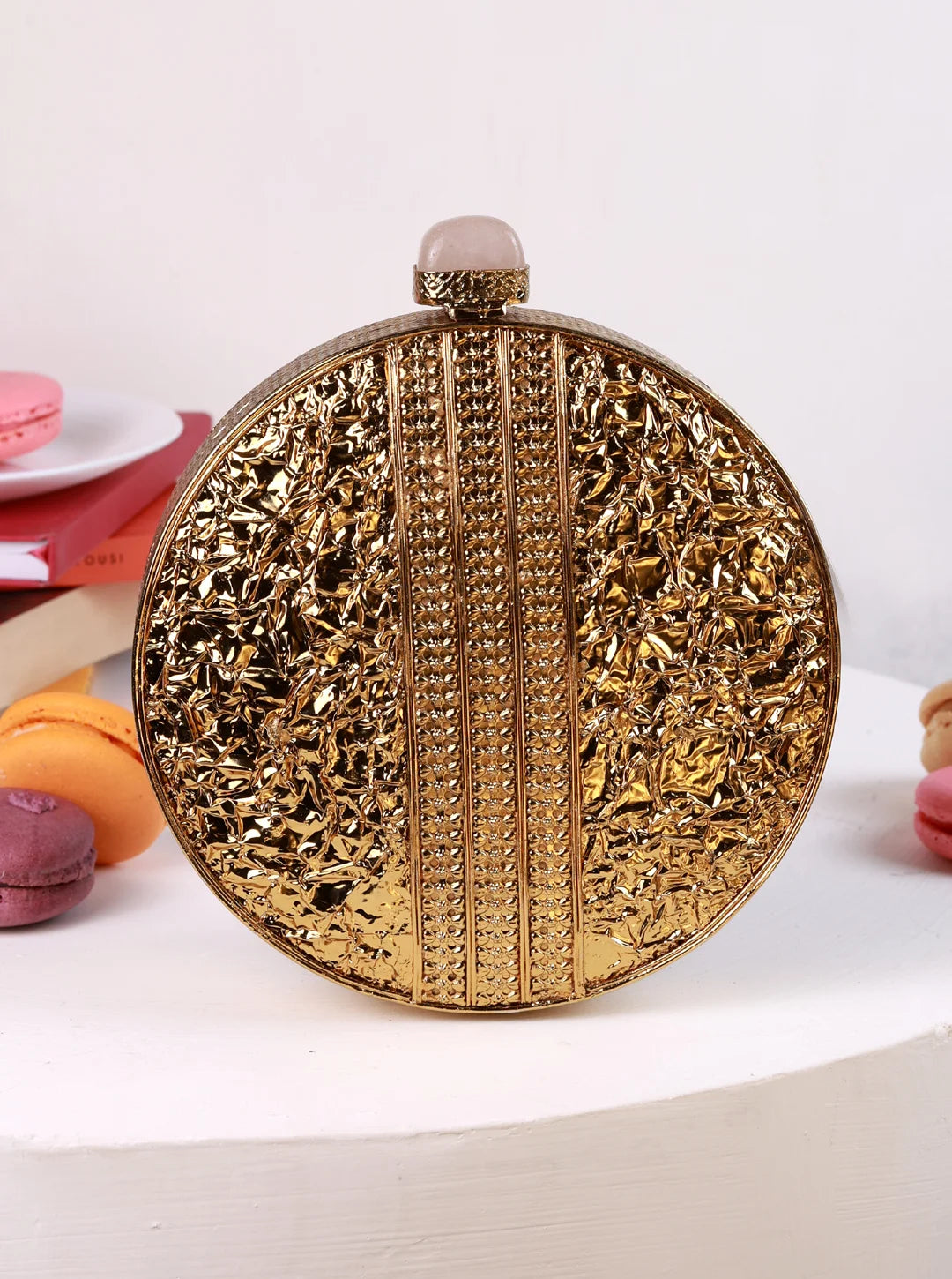 Decorative gold round clutch bag on a white background