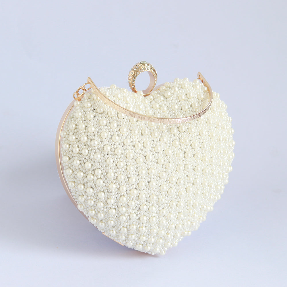 Ulfat white pearl embroidered heart clutch with hand embroidery, featuring intricate details and a stylish design by The Tan Clan.
