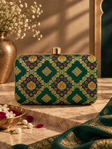 Dark green Mahi box clutch bag by THE TAN CLAN with sleek, compact design and gold-tone clasp.
