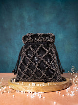 Black sequined tasselled potli bag with intricate embroidery, designed by THE TAN CLAN, perfect for festive occasions.