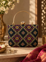 Black Mahi casket clutch bag by THE TAN CLAN with sleek design and compact size, perfect for elegant occasions.