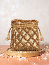 Gold sequined tasselled potli bag from THE TAN CLAN with intricate embroidery and traditional design.