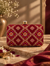 Red box clutch by THE TAN CLAN featuring a sleek, minimalist design with a smooth finish, perfect for evening accessories.