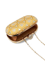 Yellow oval clutch purse by The Tan Clan with a sleek design and textured finish, perfect for elegant occasions.