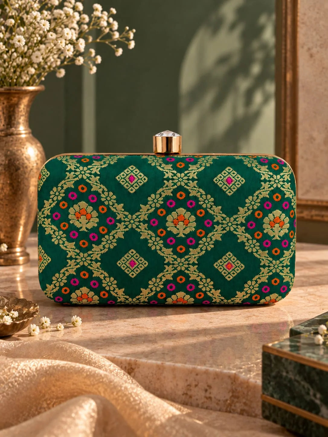 Light green Mahi box clutch by THE TAN CLAN featuring a sleek, compact design with a decorative clasp and smooth finish.