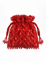 Red sequined tasselled potli bag with intricate beadwork by THE TAN CLAN, featuring a decorative drawstring tassel.