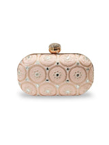 Inaara Peach Oval Clutch by The Tan Clan featuring a smooth peach-colored leather exterior and elegant oval shape.