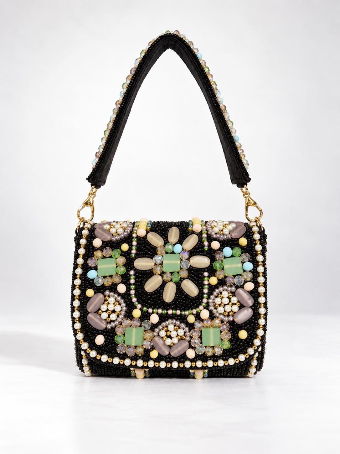Black leather mini flap purse with intricate hand embroidery and a small flap closure, designed by THE TAN CLAN.