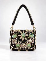 Black leather mini flap purse with intricate hand embroidery and a small flap closure, designed by THE TAN CLAN.