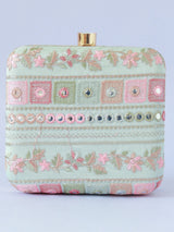 The Tan Clan Phulwaari floral box clutch with intricate embroidery and vibrant floral design on a structured purse.