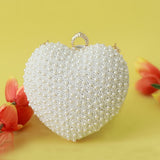 Ulfat All White Pearl Hand Embroidered Heart Clutch by The Tan Clan, featuring intricate pearl embroidery and a heart-shaped design.