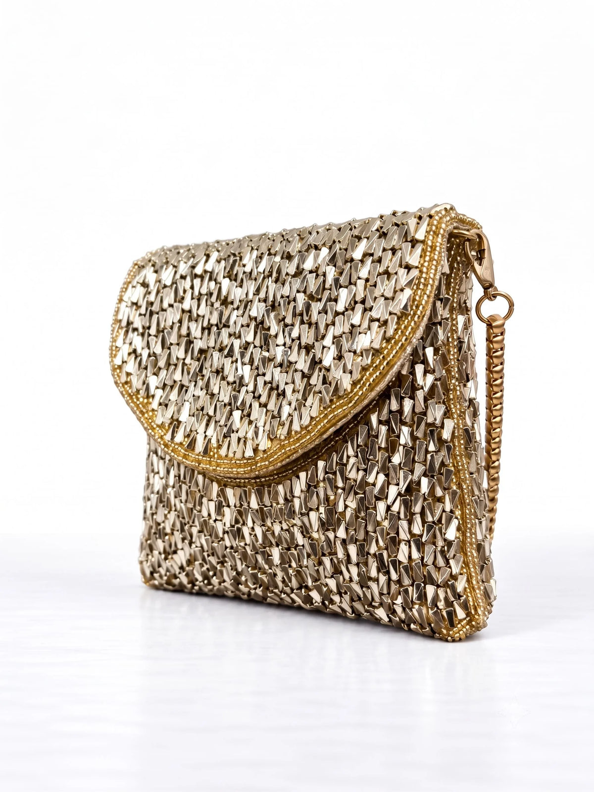Anaya Gold Envelope Bag by THE TAN CLAN featuring a sleek gold clutch with a minimalist envelope design.