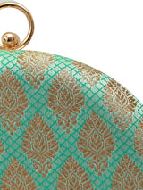 Green round clutch by The Tan Clan featuring a classic design with a smooth, vibrant exterior and compact shape.
