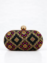Black oval clutch bag from THE TAN CLAN with a sleek design and smooth leather finish.