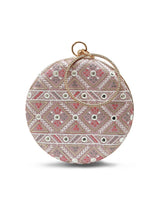 Pink round clutch purse by The Tan Clan with a smooth surface and compact design, perfect for evening or special occasions.