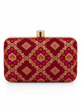 Red box clutch bag by THE TAN CLAN with sleek design and minimal details, perfect for elegant occasions.