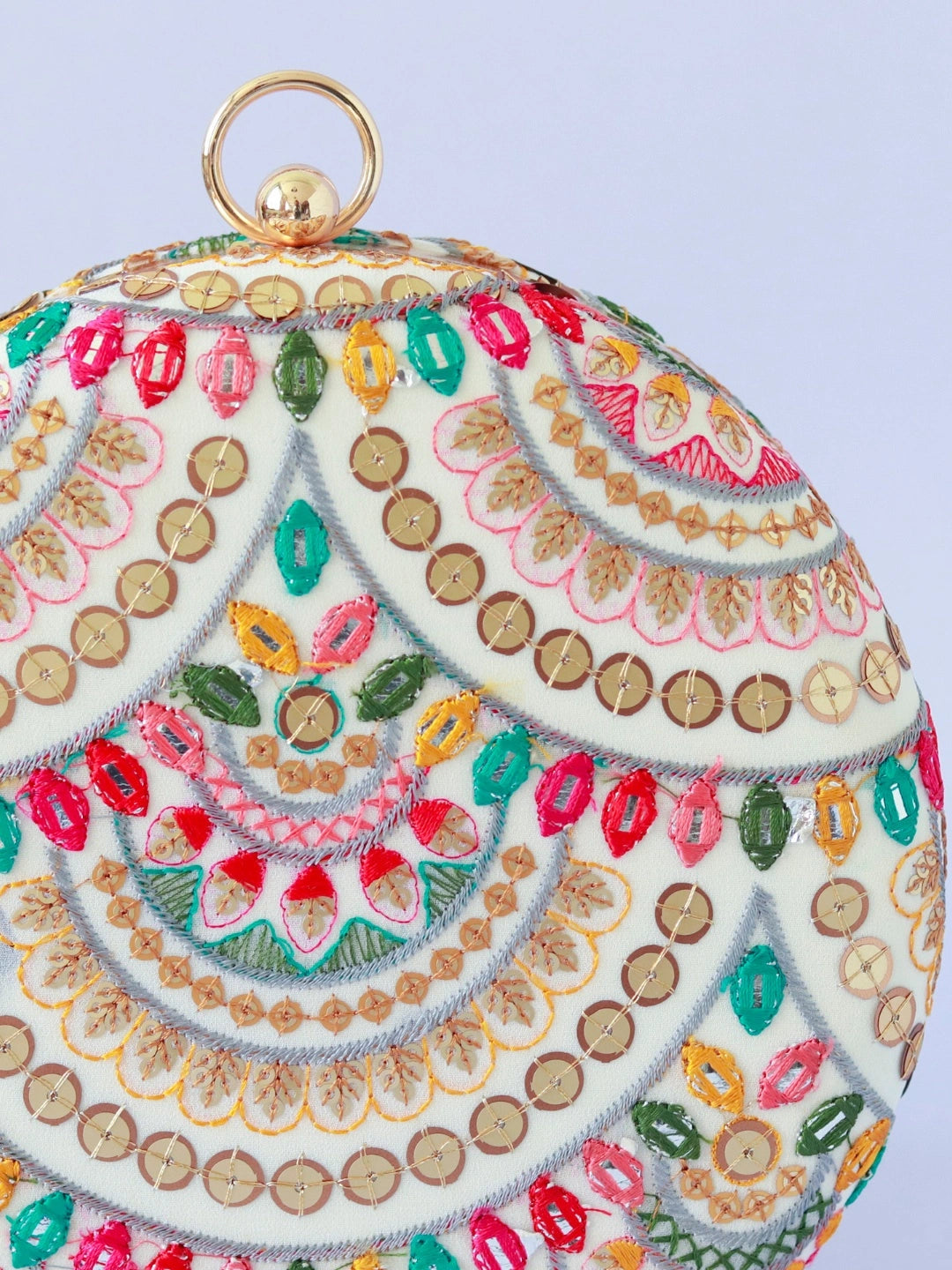 Multicolour embroidered clutch bag by The Tan Clan with intricate patterns and decorative embellishments.