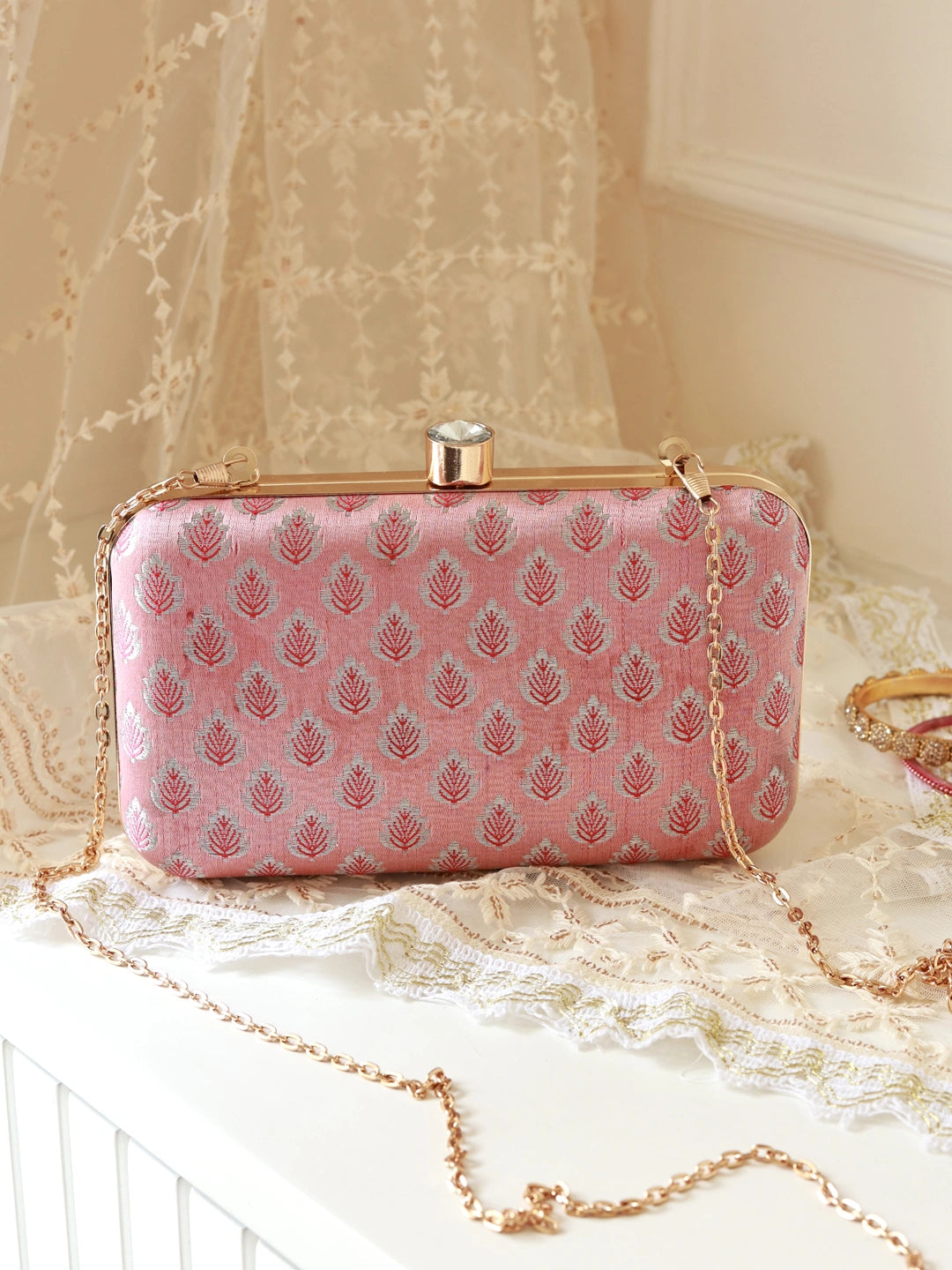 Elegant pink box clutch by The Tan Clan with a sleek design and gold clasp, perfect for evening occasions.