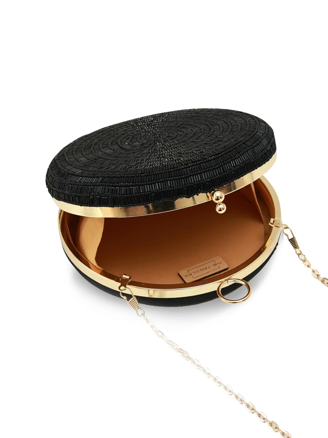 Black woven clutch with gold accents on a white background