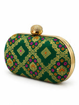 Dark green oval clutch bag by THE TAN CLAN with sleek design and compact size, perfect for elegant occasions.