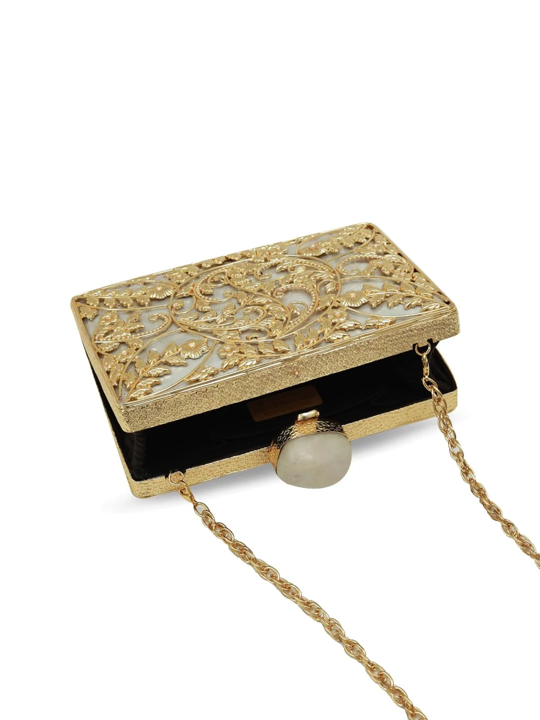 Gold clutch with intricate design and chain strap on a white background