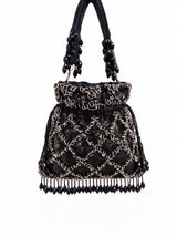Black sequined tasselled potli bag by THE TAN CLAN with intricate beadwork and hanging tassels.